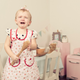 Little girl in apron crying